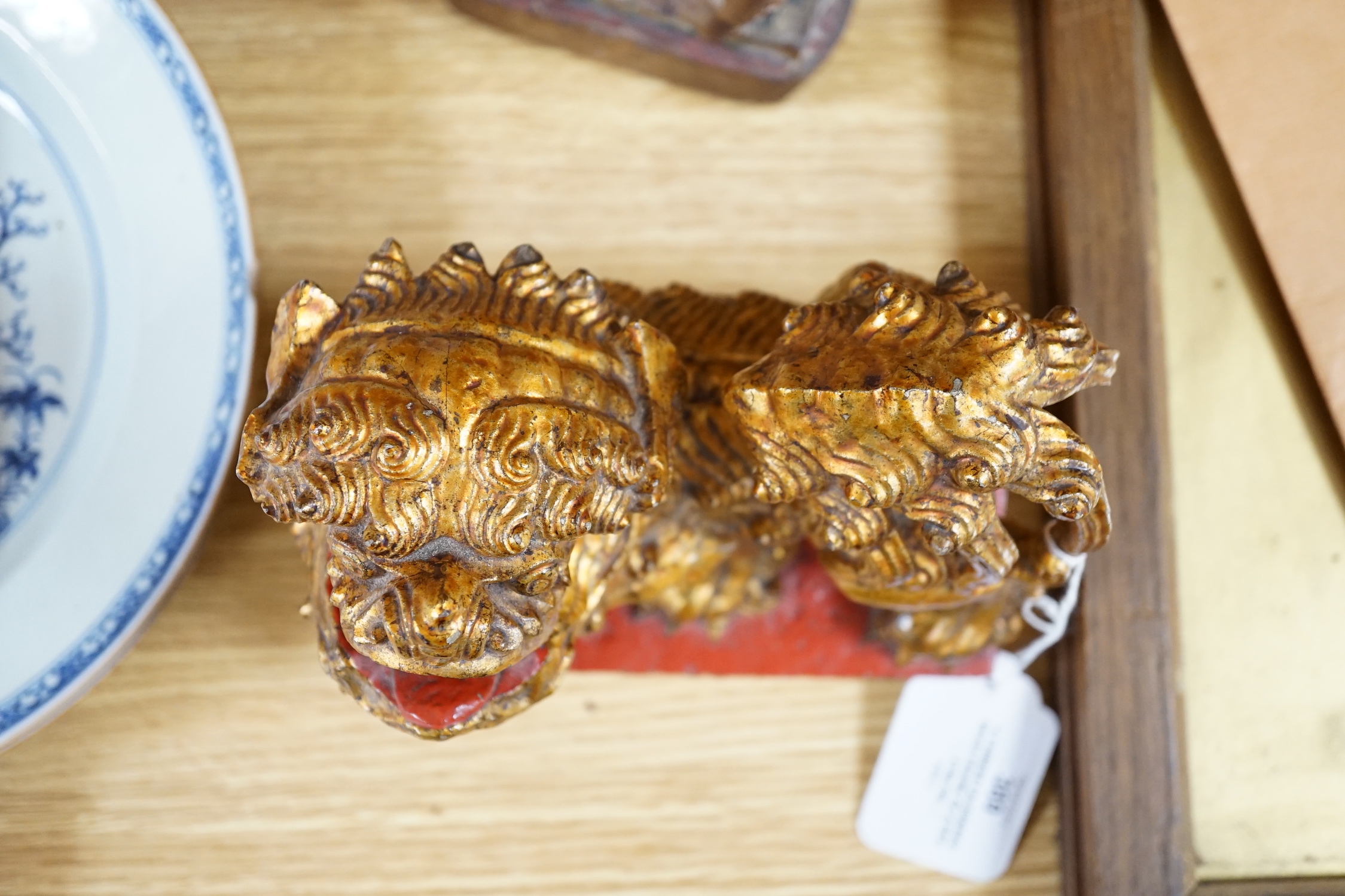 A Chinese lacquered wood figure of a seated woman and a Buddhist lion, tallest 20.5cm